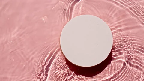 Empty white circle podium on transparent clear water texture with waves in Stock Footage 216023630