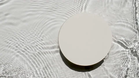 Empty white circle podium on transparent clear water texture with waves in Stock Footage 222982397