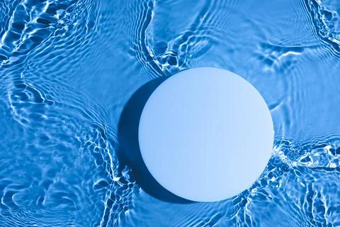 Empty white circle podium on transparent blue water background with copy space Stock Photos