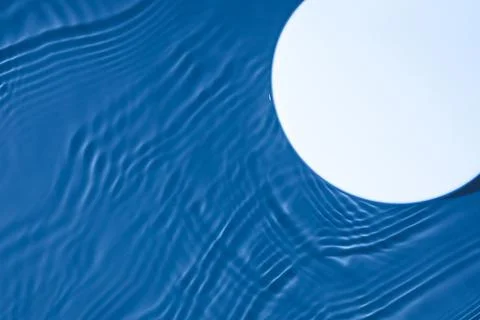 Empty white circle podium on transparent dark blue water background Stock Photos