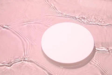 Empty white circle podium on transparent pink clear water background Stock Photos