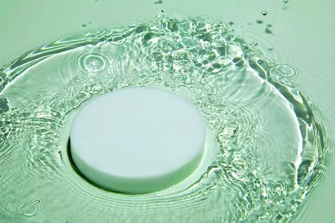 Empty white circle podium on transparent green clear water background Stock Photos