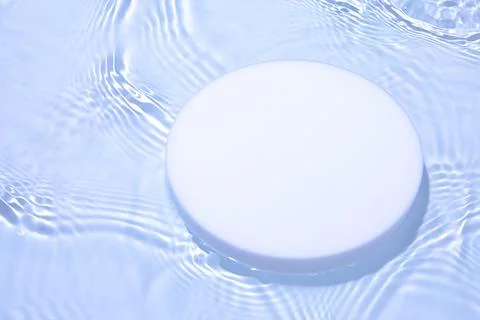 Empty white circle podium on transparent blue water background with copy space Stock Photos
