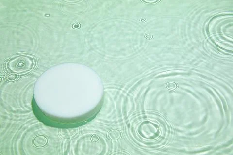 Empty white circle podium on transparent green clear water background Stock Photos