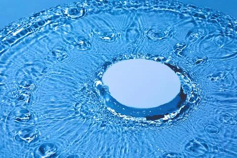 Empty white circle podium on transparent dark blue water background Stock Photos