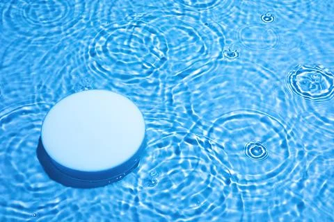 Empty white circle podium on transparent blue water background with copy space Stock Photos