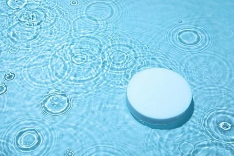 Empty white circle podium on transparent blue water background with copy space Stock Photos