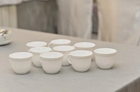 Empty white clean coffee cups on the table Stock Photos