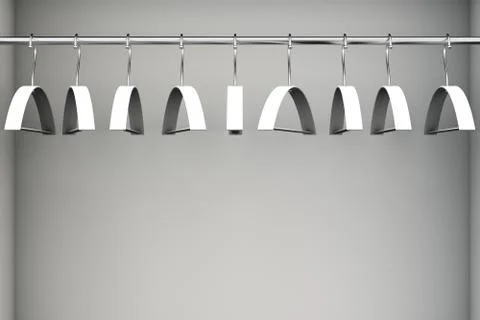 Empty white coat hangers on clothes rail. With copy space. Illustrazione stock