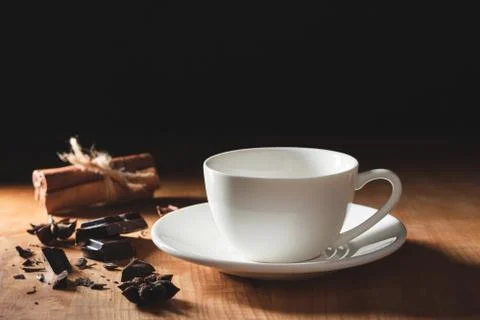 Empty white coffee cup or cappuccino mug with chopped chocolate, cinnamon sti Stock Photos