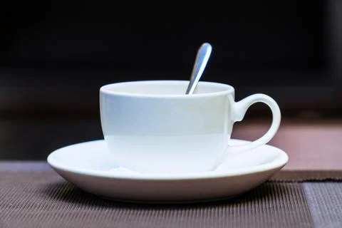 An empty white coffee cup with a teaspoon on table 写真素材