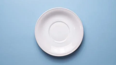 Empty White Coffee Saucer on Blue Background Top View Stock Photos