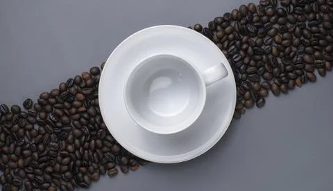 Empty White Cup on Diagonal Roasted Coffee Beans Background Stock Photos