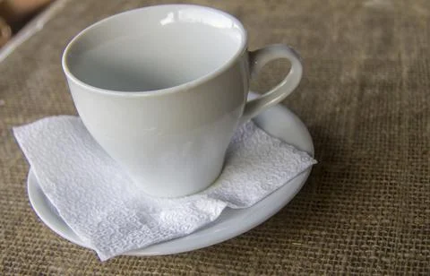Empty white cup for herbal tea on the table outdoors Stock Photos