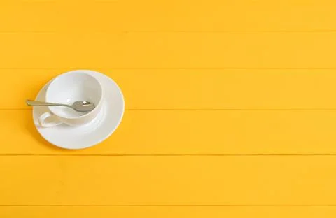 Empty White Cup with Spoon on Yellow Wooden Background Stock Photos
