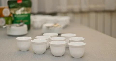Empty white cups on the table Stock Photos