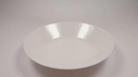 Empty white dish on a table Stock Photos