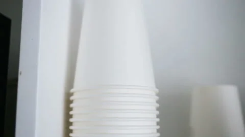Empty white disposable paper cups are worth a stack. Real time, indoors, day, cl Stock Footage 93514412