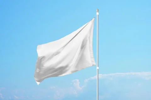 Empty white flag in the wind on clear blue sky, ideal for promotional design, Stock Photos