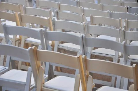 Empty white folding chairs Stock Photos