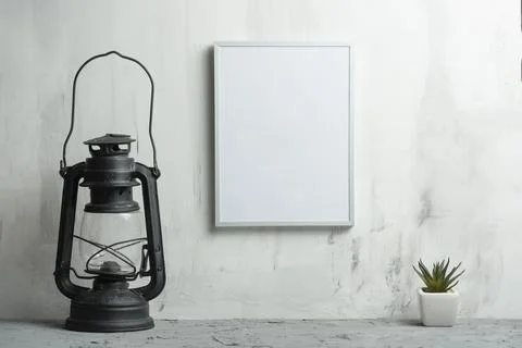 Empty white frame with a flower with a lamp on the wall background. The conce Stock Photos