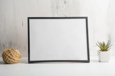 Empty white frame with flower on wall background. The concept of design and f Stock Photos