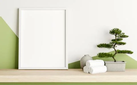 Empty white frame with towels and bonsai pot on wooden hanging shelf in a w.. Ilustração Stock