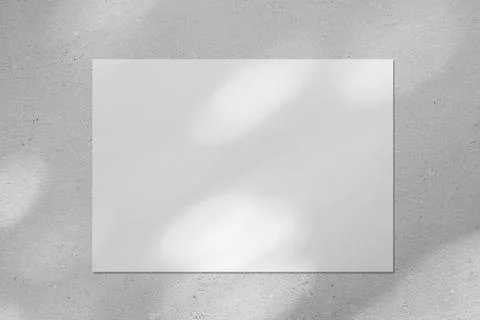 Empty white horizontal poster mockup with diagonal window shadow on the wall Stock Photos