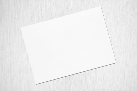 Empty white horizontal rectangle poster mockup lying diagonally on grey concr Stock Photos