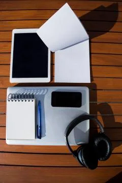 Empty white notepad with mobile phone, laptop, headphones and tablet Stock Photos