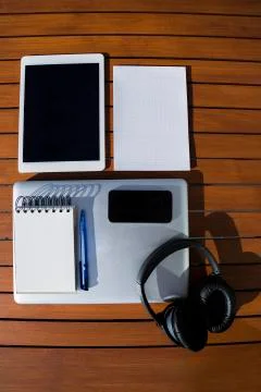 Empty white notepad with mobile phone, laptop, headphones and tablet Stock Photos