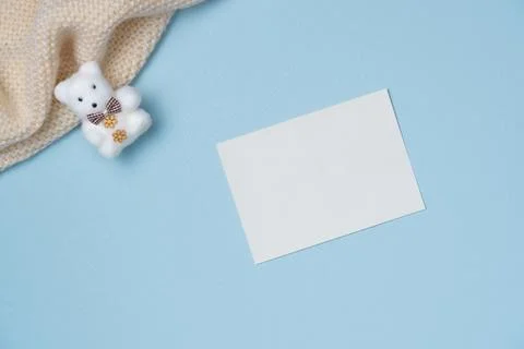 Empty white paper list with bear toy on blue background from above. Copy spac Stock Photos