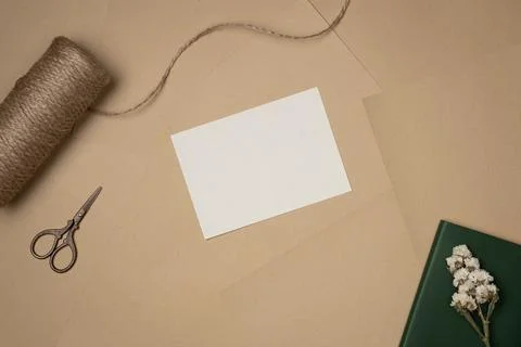 Empty white paper list with string, scissors and flower on sheets of paper ba Stock Photos