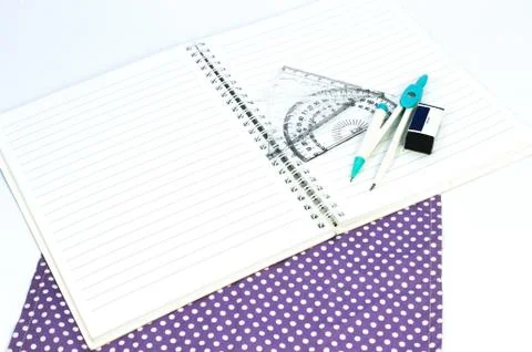 Empty white paper notebook with ruler, protractor, angle, triangle, square on Stock Photos