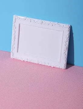 Empty white picture frame on pink and blue background 스톡 사진