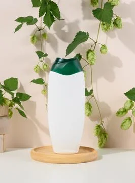 Empty white plastic bottle for gel, shampoo and other liquid cosmetics on a b Stock Photos