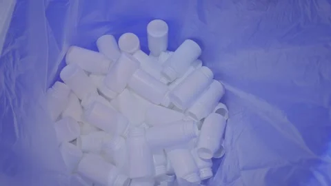 Empty white plastic bottles are falling into a large pile, heap - close up Stock Footage 341316426