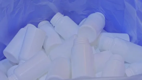 Empty white plastic bottles are falling into a large pile, heap - close up Stock Footage 341851197