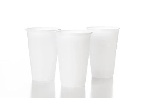 Empty white plastic cup isolated on white background shoot in studio. Stock Photos