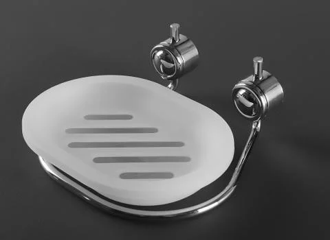 Empty white plastic soap-dish with metal holder on gray background Stock-Fotos