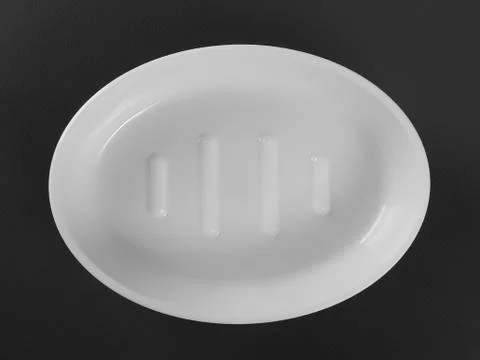 Empty white plastic soap-dish on gray background Photos