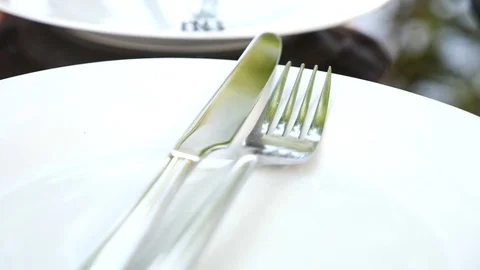 Empty white plate and cutlery on it. fork and knife. slow motion Stock Footage 77768594