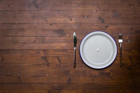 Empty white plate with a fork and a knife Stock Photos