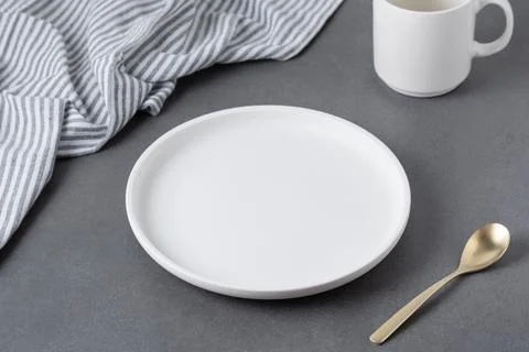 Empty white plate on grey table 스톡 사진