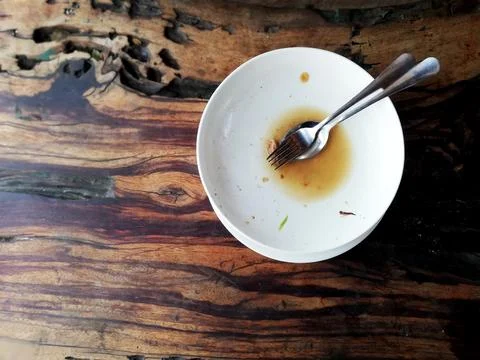 Empty white plate, placed on the brown wooden table Stock Photos
