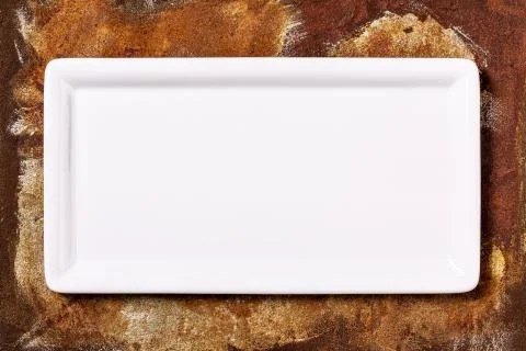 Empty white plate on rusty background Stock Photos