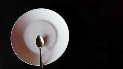 Empty white plate with spoon on black background minimal concept Stock Footage 324959251