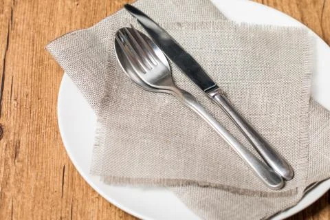 Empty white plate spoon, fork, knife Stock Photos