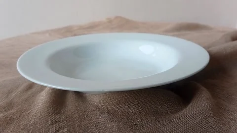 An empty white plate on a table Stock Footage 146249892