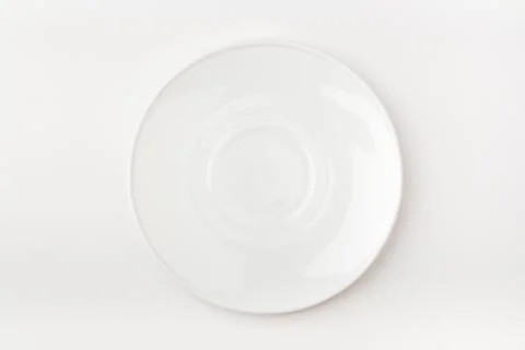 An empty white plate on a white background. Blank plate. Top view Stock Photos